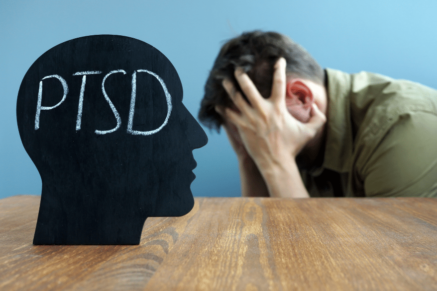 ptsd- man holding his head between hands